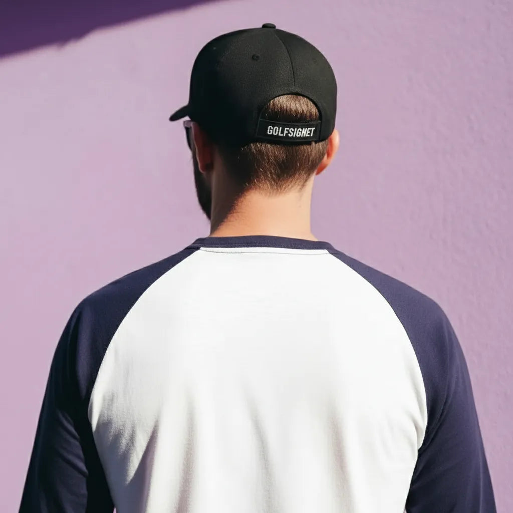 Person wearing a black cap with 'Golfsgore' branding against a purple background
