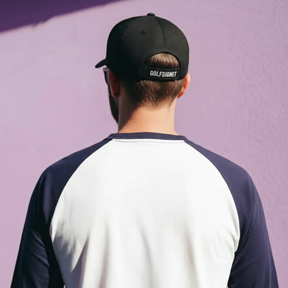 Person wearing a black cap with 'Golfsgore' branding against a purple background